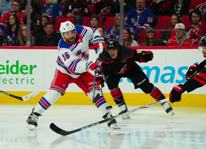 Mar 12, 2024; Raleigh, North Carolina, USA; New York Rangers center Vincent Trocheck (16) gets the shot off past Carolina Hurricanes left wing Teuvo Teravainen (86) during the second period at PNC Arena. Mandatory Credit: James Guillory-USA TODAY Sports