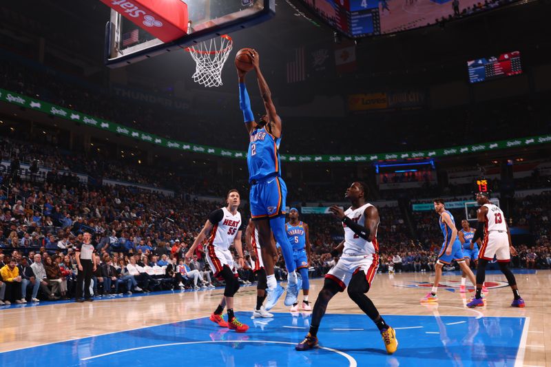 OKLAHOMA CITY, OK - MARCH 8:  Shai Gilgeous-Alexander #2 of the Oklahoma City Thunder grabs a rebound during the game against the Miami Heat on March 8, 2024 at Paycom Arena in Oklahoma City, Oklahoma. NOTE TO USER: User expressly acknowledges and agrees that, by downloading and or using this photograph, User is consenting to the terms and conditions of the Getty Images License Agreement. Mandatory Copyright Notice: Copyright 2024 NBAE (Photo by Zach Beeker/NBAE via Getty Images)