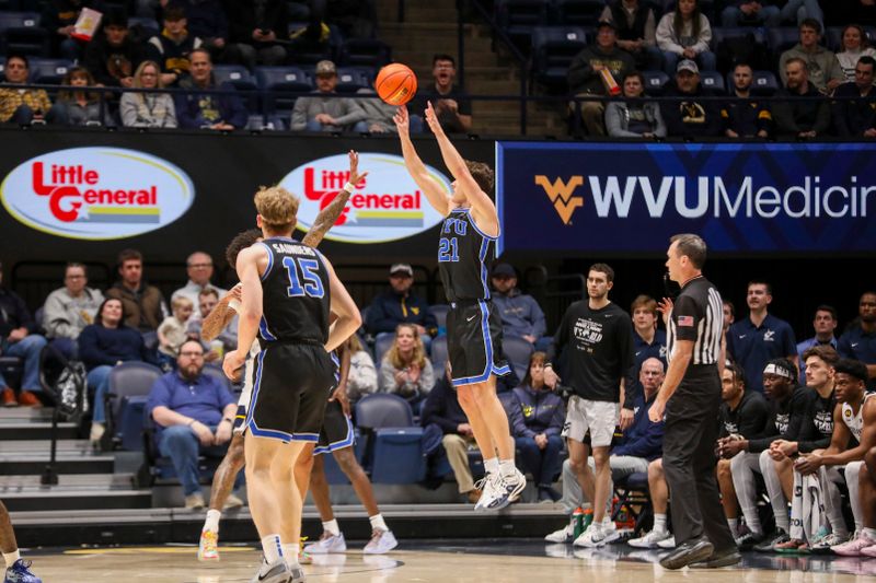 Feb 11, 2025; Morgantown, West Virginia, USA; Brigham Young Cougars guard Trevin Knell (21) shoots a three pointer during the first half against the West Virginia Mountaineers at WVU Coliseum. Mandatory Credit: Ben Queen-Imagn Images