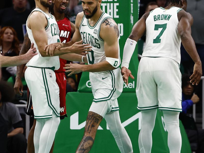 BOSTON, MA - APRIL 21: Delon Wright #4 of the Miami Heat looks on as Derrick White #9 of the Boston Celtics checks on Jayson Tatum #0 after he was he was knocked to the floor during the second half of game one of the Eastern Conference First Round Playoffs at TD Garden on April 21, 2024 in Boston, Massachusetts. NOTE TO USER: User expressly acknowledges and agrees that, by downloading and/or using this Photograph, user is consenting to the terms and conditions of the Getty Images License Agreement. (Photo By Winslow Townson/Getty Images)