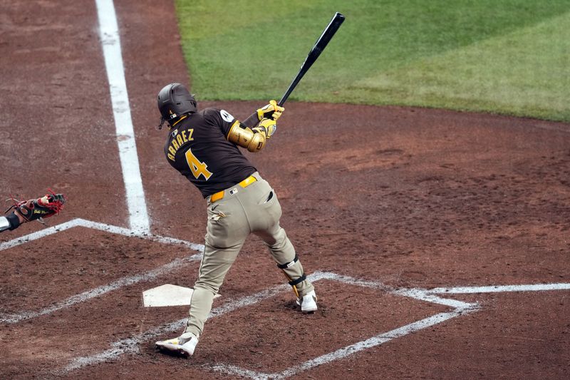 Sep 27, 2024; Phoenix, Arizona, USA; San Diego Padres first base Luis Arraez (4) hits a double against the Arizona Diamondbacks during the fifth inning at Chase Field. Mandatory Credit: Joe Camporeale-Imagn Images