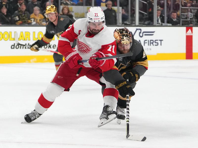 Jan 19, 2023; Las Vegas, Nevada, USA; Vegas Golden Knights right wing Phil Kessel (8) steals the puck from Detroit Red Wings center Dylan Larkin (71) during the first period at T-Mobile Arena. Mandatory Credit: Stephen R. Sylvanie-USA TODAY Sports