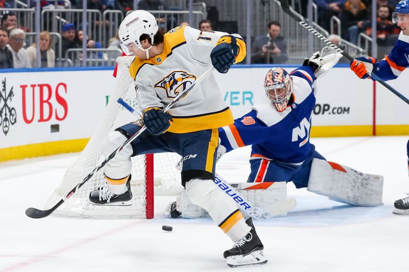 Apr 6, 2024; Elmont, New York, USA; Nashville Predators right wing Luke Evangelista (77) shoots the puck against New York Islanders goaltender Semyon Varlamov (40) during the first period at UBS Arena. Mandatory Credit: Tom Horak-USA TODAY Sports