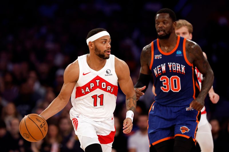 NEW YORK, NEW YORK - JANUARY 20: Bruce Brown #11 of the Toronto Raptors dribbles as Julius Randle #30 of the New York Knicks defends during the second half at Madison Square Garden on January 20, 2024 in New York City. The Knicks won 126-120. NOTE TO USER: User expressly acknowledges and agrees that, by downloading and/or using this Photograph, user is consenting to the terms and conditions of the Getty Images License Agreement. (Photo by Sarah Stier/Getty Images)