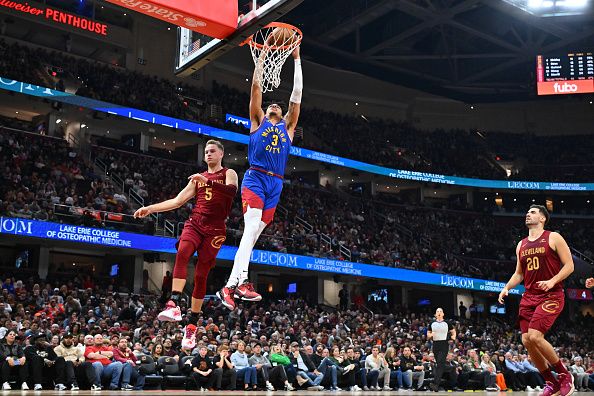 CLEVELAND, OHIO - NOVEMBER 19: Julian Strawther #3 of the Denver Nuggets dunks over Sam Merrill #5 of the Cleveland Cavaliers during the second quarter at Rocket Mortgage Fieldhouse on November 19, 2023 in Cleveland, Ohio. NOTE TO USER: User expressly acknowledges and agrees that, by downloading and or using this photograph, User is consenting to the terms and conditions of the Getty Images License Agreement. (Photo by Jason Miller/Getty Images)