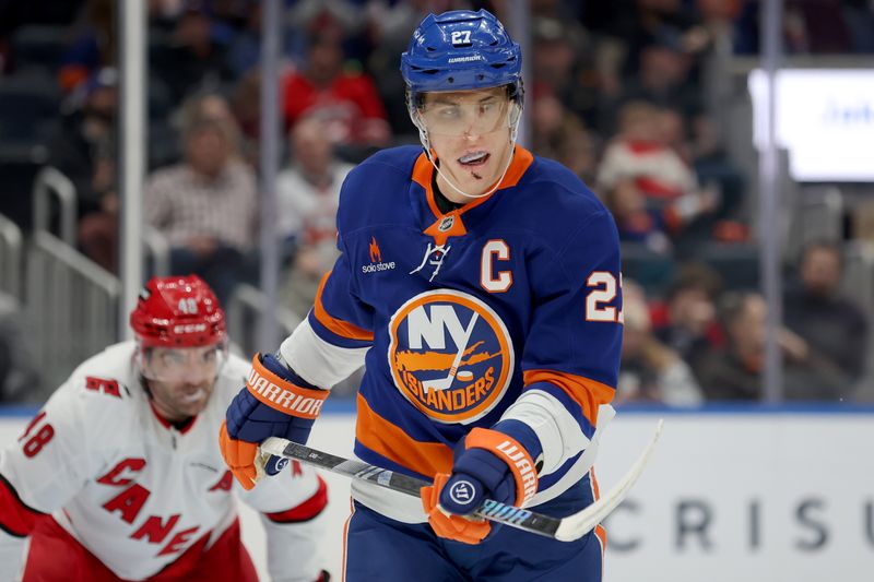 Jan 25, 2025; Elmont, New York, USA; New York Islanders left wing Anders Lee (27) skates against the Carolina Hurricanes during the first period at UBS Arena. Mandatory Credit: Brad Penner-Imagn Images
