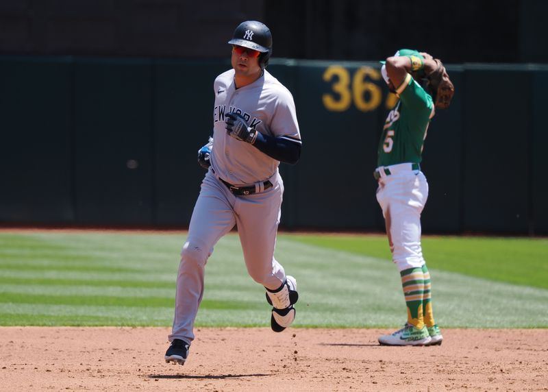 Jun 29, 2023; Oakland, California, USA; New York Yankees left fielder Isiah Kiner-Falefa (12) rounds the bases ahead of Oakland Athletics second baseman Tony Kemp (5) on a solo home run during the second inning at Oakland-Alameda County Coliseum. Mandatory Credit: Kelley L Cox-USA TODAY Sports