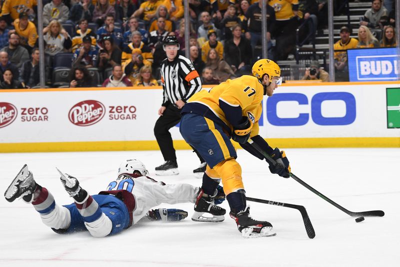 Mar 2, 2024; Nashville, Tennessee, USA; Nashville Predators center Mark Jankowski (17) gets past Colorado Avalanche center Ross Colton (20) before shooting the puck during the first period at Bridgestone Arena. Mandatory Credit: Christopher Hanewinckel-USA TODAY Sports