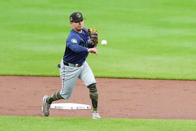 May 18, 2024; Baltimore, Maryland, USA; Seattle Mariners shortstop Dylan Moore (25) throws out Baltimore Orioles first baseman Ryan O'Hearn (not pictured) after fielding a ground ball during the first inning at Oriole Park at Camden Yards. Mandatory Credit: Gregory Fisher-USA TODAY Sports