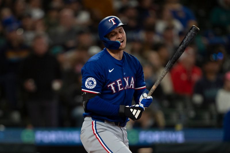 Jun 15, 2024; Seattle, Washington, USA; Texas Rangers shortstop Corey Seager (5) reacts after hitting pop fly during the fifth inning against the Seattle Mariners at T-Mobile Park. Mandatory Credit: Stephen Brashear-USA TODAY Sports