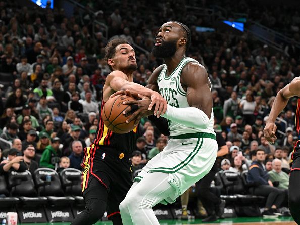 BOSTON, MASSACHUSETTS - NOVEMBER 26: Trae Young #11 of the Atlanta Hawks fouls Jaylen Brown #7 of the Boston Celtics during the third quarter at the TD Garden on November 26, 2023 in Boston, Massachusetts. NOTE TO USER: User expressly acknowledges and agrees that, by downloading and or using this photograph, User is consenting to the terms and conditions of the Getty Images License Agreement. (Photo by Brian Fluharty/Getty Images)