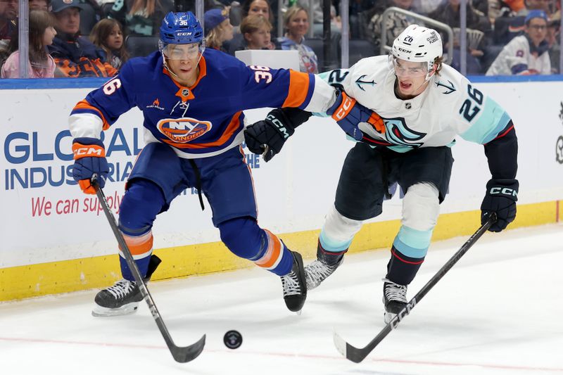 Dec 5, 2024; Elmont, New York, USA; New York Islanders defenseman Isaiah George (36) and Seattle Kraken center Ryan Winterton (26) fight for the puck during the third period at UBS Arena. Mandatory Credit: Brad Penner-Imagn Images