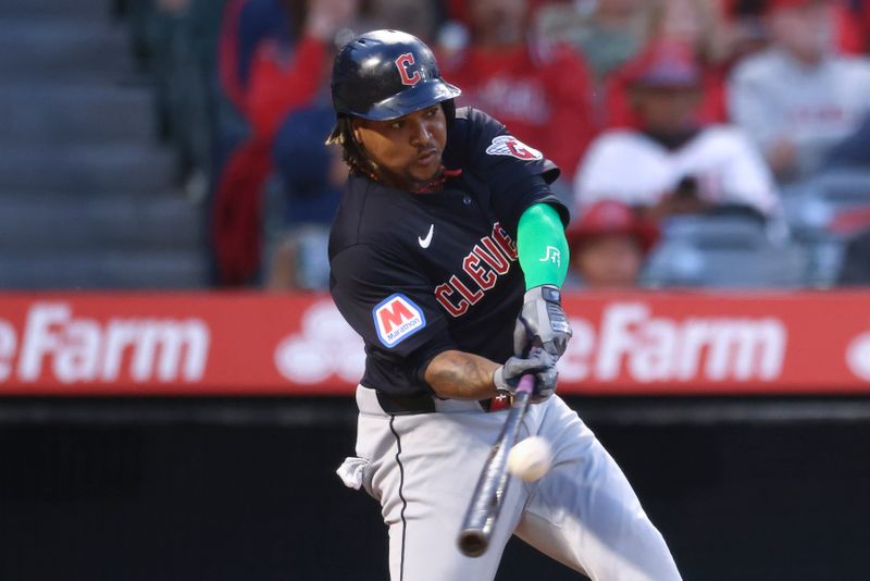 May 24, 2024; Anaheim, California, USA; Cleveland Guardians third base José Ramírez (11) hits a home run against the Los Angeles Angels during fourth inning of a game at Angel Stadium. Mandatory Credit: Jessica Alcheh-USA TODAY Sports