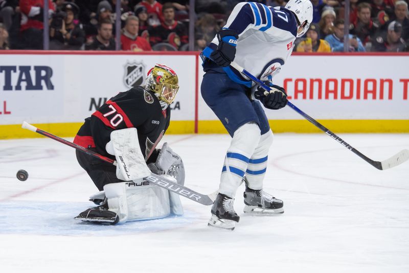 Jan 20, 2024; Ottawa, Ontario, CAN; Ottawa Senators goalie Joonas Korpisalo (70) makes a save in front of Winnipeg Jets center Adam Lowry (17) in the second period at the Canadian Tire Centre. Mandatory Credit: Marc DesRosiers-USA TODAY Sports