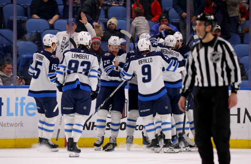 Dec 5, 2024; Buffalo, New York, USA;  The Winnipeg Jets celebrate an overtime win against the Buffalo Sabres at KeyBank Center. Mandatory Credit: Timothy T. Ludwig-Imagn Images