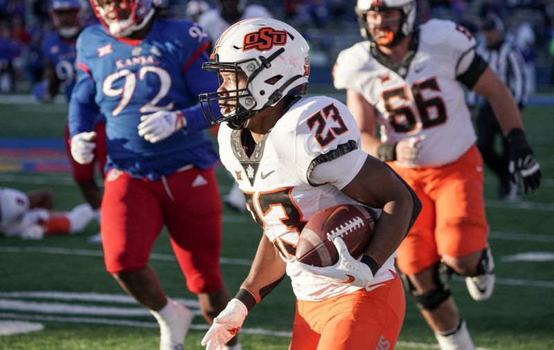 Nov 5, 2022; Lawrence, Kansas, USA; Oklahoma State Cowboys running back Jaden Nixon (23) runs the ball against the Kansas Jayhawks during the second half of the game at David Booth Kansas Memorial Stadium. Mandatory Credit: Denny Medley-USA TODAY Sports