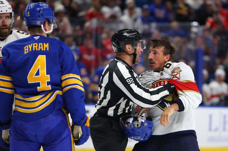 Oct 18, 2025; Buffalo, New York, USA;  Florida Panthers left wing Brad Marchand (63) gets held back by the linesman during the second period against the Buffalo Sabres at KeyBank Center. Mandatory Credit: Timothy T. Ludwig-Imagn Images