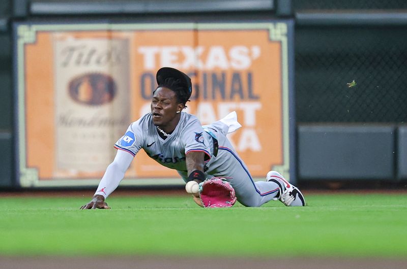 Jul 10, 2024; Houston, Texas, USA; Miami Marlins center fielder Jazz Chisholm Jr (2) dives but is unable to catch a fly ball during the first inning against the Houston Astros at Minute Maid Park. Mandatory Credit: Troy Taormina-USA TODAY Sports