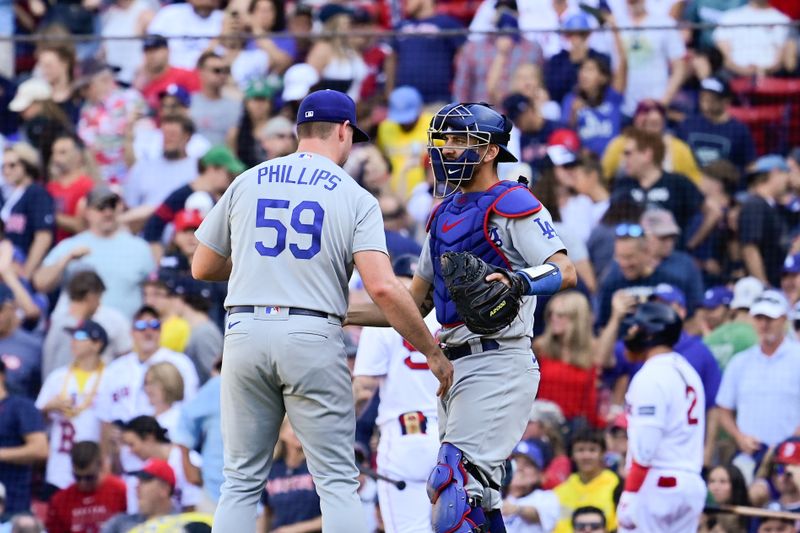 Aug 27, 2023; Boston, Massachusetts, USA; Los Angeles Dodgers relief pitcher Evan Phillips (59) and catcher Austin Barnes (15) celebrates a win over the Boston Red Sox at Fenway Park. Mandatory Credit: Eric Canha-USA TODAY Sports