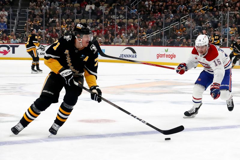 Feb 22, 2024; Pittsburgh, Pennsylvania, USA; Pittsburgh Penguins center Evgeni Malkin (71) skates with the puck as Montreal Canadiens center Alex Newhook (15) chases during the first period at PPG Paints Arena. Mandatory Credit: Charles LeClaire-USA TODAY Sports