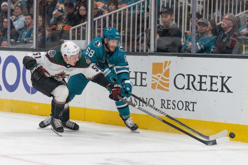 Dec 21, 2023; San Jose, California, USA; Arizona Coyotes defenseman Troy Stecher (51) and San Jose Sharks center Mike Hoffman (68) fight for control of the puck during the second period at SAP Center at San Jose. Mandatory Credit: Stan Szeto-USA TODAY Sports