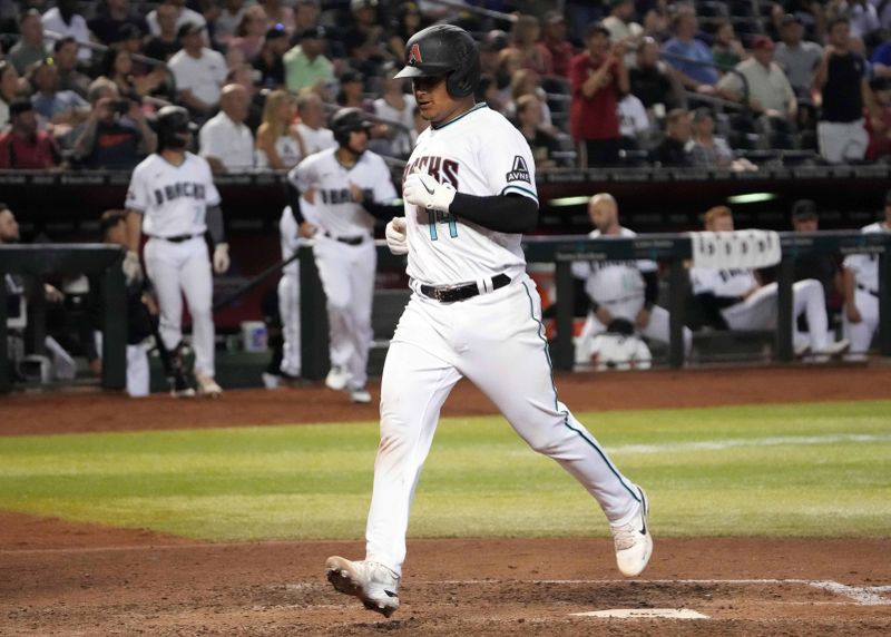 Apr 25, 2023; Phoenix, Arizona, USA; Arizona Diamondbacks catcher Gabriel Moreno (14) scores a run against the Kansas City Royals during the seventh inning at Chase Field. Mandatory Credit: Joe Camporeale-USA TODAY Sports