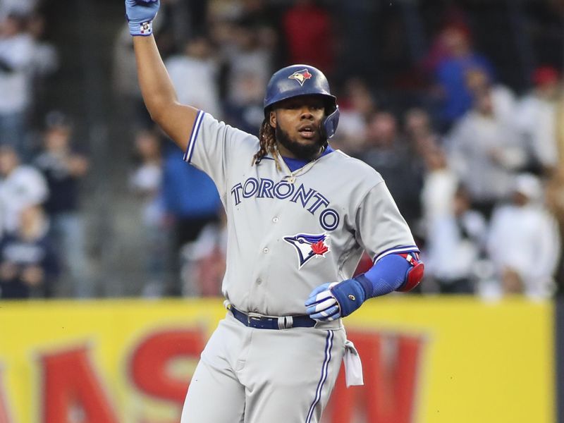 Apr 13, 2022; Bronx, New York, USA; Toronto Blue Jays first baseman Vladimir Guerrero Jr. (27) signals home run ruling in the first inning against the New York Yankees at Yankee Stadium. Mandatory Credit: Wendell Cruz-USA TODAY Sports