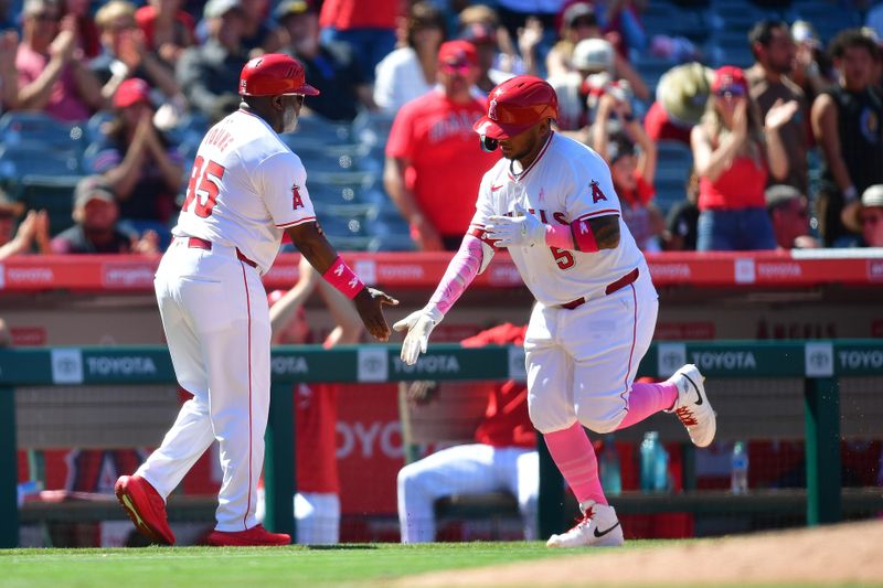 May 12, 2024; Anaheim, California, USA; Los Angeles Angels designated hitter Willie Calhoun (5) is greeted by third base coach Eric Young Sr. (85) after hitting a solo home run against the Kansas City Royals during the ninth inning at Angel Stadium. Mandatory Credit: Gary A. Vasquez-USA TODAY Sports