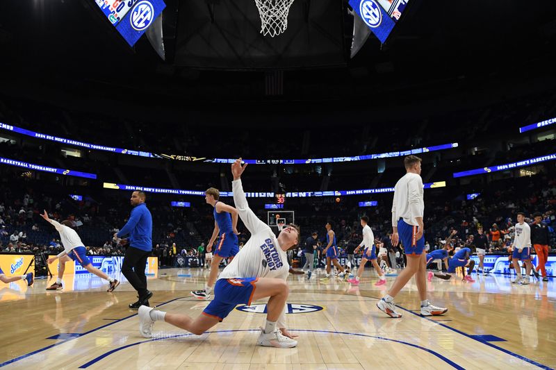 Mar 17, 2024; Nashville, TN, USA; Florida Gators players stretch during warm ups before the SEC Tournament Championship game against the Auburn Tigers at Bridgestone Arena. Mandatory Credit: Christopher Hanewinckel-USA TODAY Sports