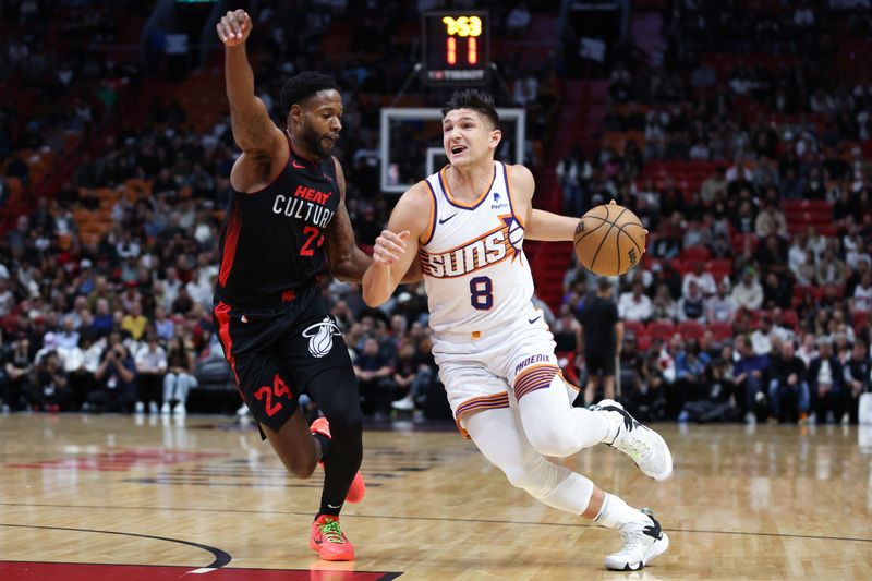 MIAMI, FLORIDA - JANUARY 29: Grayson Allen #8 of the Phoenix Suns drives against Haywood Highsmith #24 of the Miami Heat during the first quarter of the game at Kaseya Center on January 29, 2024 in Miami, Florida. NOTE TO USER: User expressly acknowledges and agrees that, by downloading and or using this photograph, User is consenting to the terms and conditions of the Getty Images License Agreement. (Photo by Megan Briggs/Getty Images)