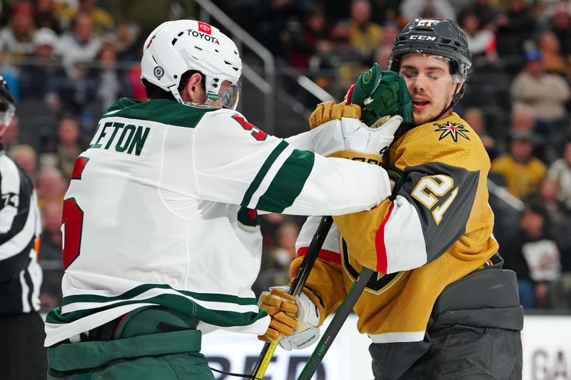 Feb 12, 2024; Las Vegas, Nevada, USA; Minnesota Wild defenseman Jake Middleton (5) shoves Vegas Golden Knights center Brett Howden (21) during the third period at T-Mobile Arena. Mandatory Credit: Stephen R. Sylvanie-USA TODAY Sports