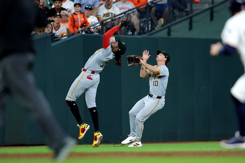 Jul 31, 2024; Houston, Texas, USA; Pittsburgh Pirates shortstop Oneil Cruz (15) and left fielder Bryan Reynolds (10) are unable to catch a fly ball during the third inning at Minute Maid Park. Mandatory Credit: Erik Williams-USA TODAY Sports