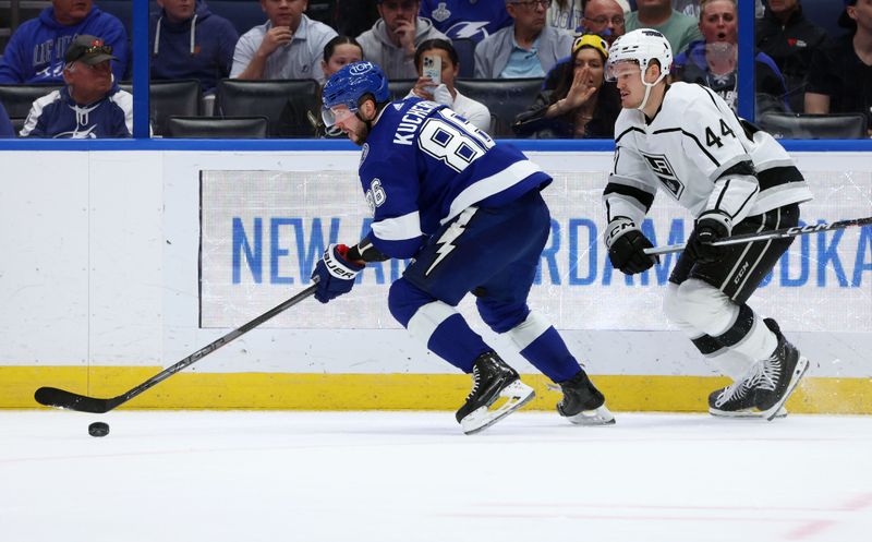 Jan 9, 2024; Tampa, Florida, USA; Tampa Bay Lightning right wing Nikita Kucherov (86) skate as Los Angeles Kings defenseman Mikey Anderson (44) defends during the third period at Amalie Arena. Mandatory Credit: Kim Klement Neitzel-USA TODAY Sports