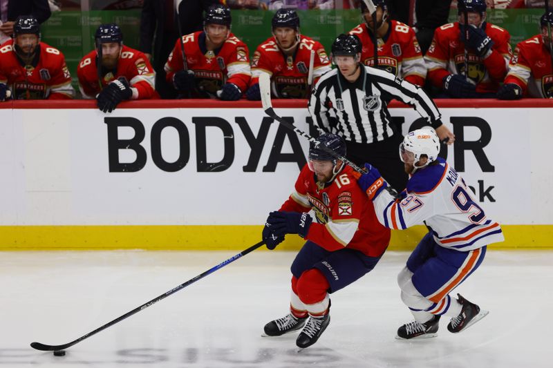 Jun 10, 2024; Sunrise, Florida, USA; Florida Panthers forward Aleksander Barkov (16) takes possession of the puck against Edmonton Oilers forward Connor McDavid (97) in game two of the 2024 Stanley Cup Final at Amerant Bank Arena. Mandatory Credit: Sam Navarro-USA TODAY Sports