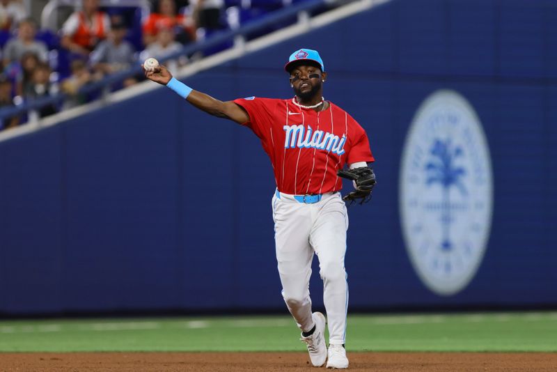 Apr 27, 2024; Miami, Florida, USA; Miami Marlins third baseman Vidal Brujan (17) throws to first base against the Washington Nationals during the fourth inning at loanDepot Park. Mandatory Credit: Sam Navarro-USA TODAY Sports