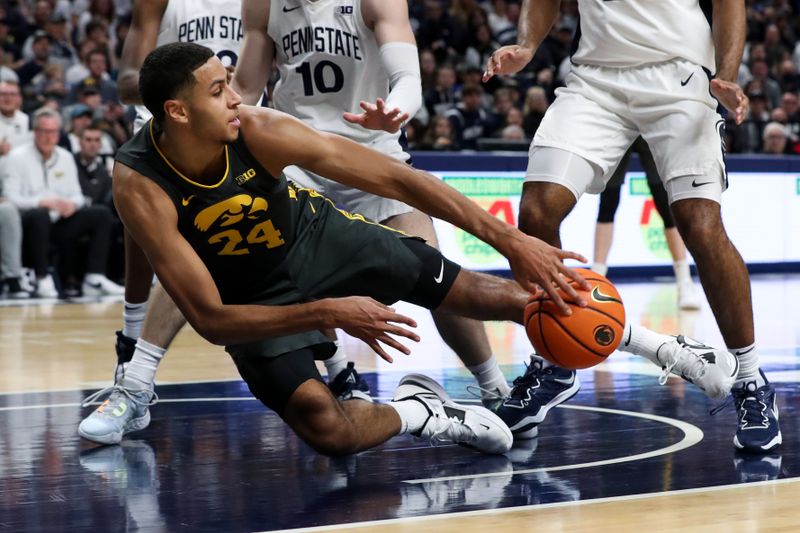 Jan 1, 2023; University Park, Pennsylvania, USA; Iowa Hawkeyes forward Kris Murray (24) tries to keep the ball in bounds during the second half against the Penn State Nittany Lions at Bryce Jordan Center. Penn State defeated Iowa 83-79. Mandatory Credit: Matthew OHaren-USA TODAY Sports