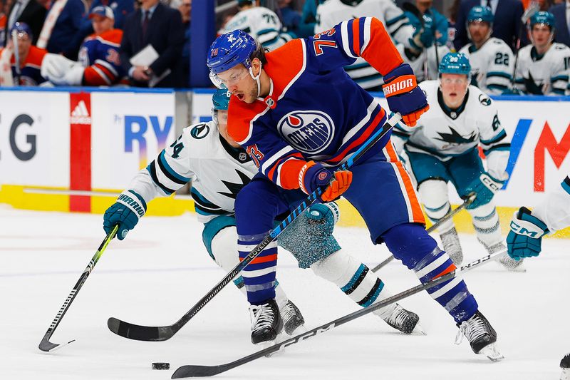 Apr 15, 2024; Edmonton, Alberta, CAN; Edmonton Oilers defensemen Vincent Desharnais (73) tries to move the puck around San Jose Sharks forward Michael Grandlund (64) during the third period at Rogers Place. Mandatory Credit: Perry Nelson-USA TODAY Sports