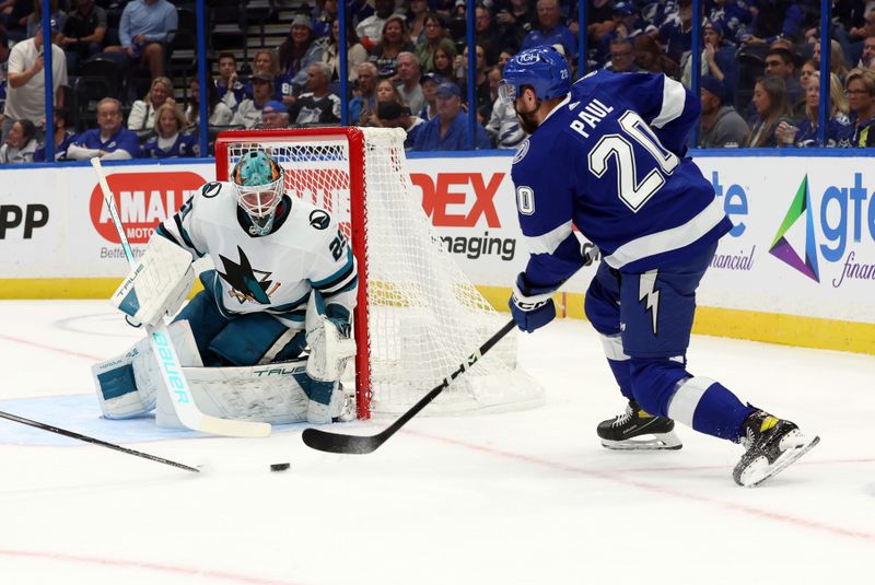 Oct 26, 2023; Tampa, Florida, USA; Tampa Bay Lightning left wing Nicholas Paul (20) shoots as San Jose Sharks goaltender Mackenzie Blackwood (29) defends during the first period at Amalie Arena. Mandatory Credit: Kim Klement Neitzel-USA TODAY Sports