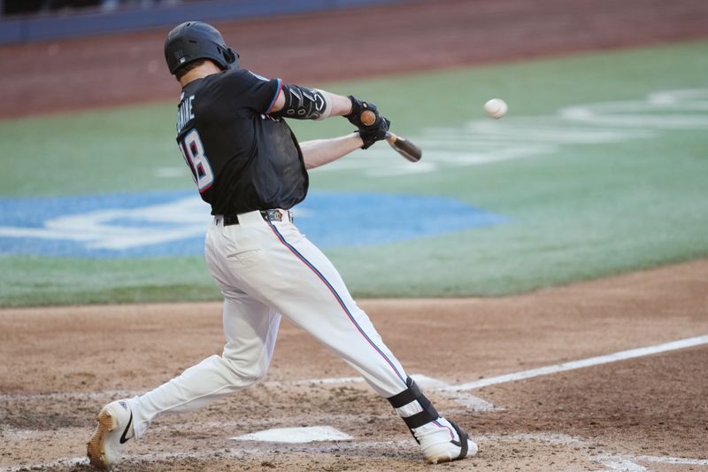 Apr 12, 2025; Miami, Florida, USA;  Miami Marlins left fielder Griffin Conine (18) hits a two run double in the fifth inning against the Washington Nationals at loanDepot Park. Mandatory Credit: Jim Rassol-Imagn Images