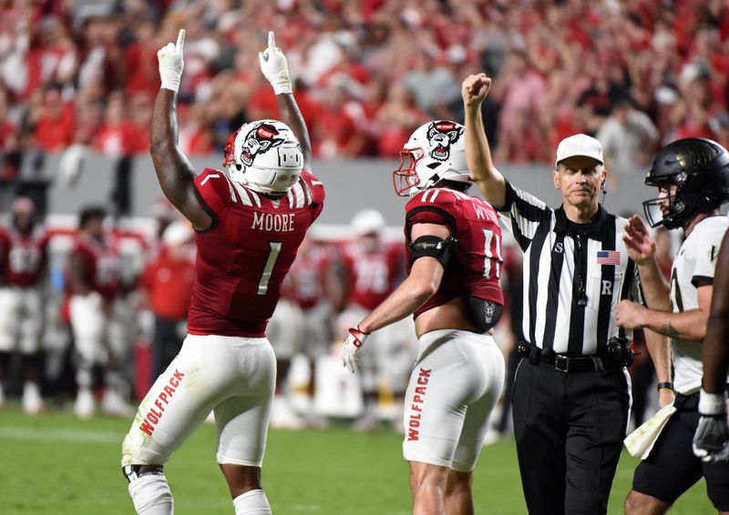 Nov 5, 2022; Raleigh, North Carolina, USA; North Carolina State Wolfpack linebacker Isaiah Moore (1) celebrates a sack during the first half against the Wake Forest Demon Deacons at Carter-Finley Stadium. Mandatory Credit: Rob Kinnan-USA TODAY Sports