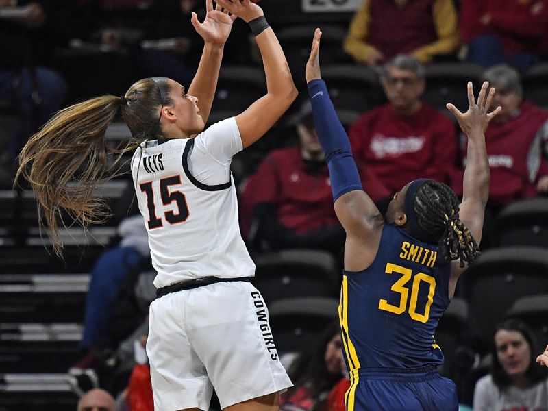 Mar 10, 2023; Kansas City, MO, USA;  Oklahoma State Cowgirls guard Lexy Keys (15) shoots the ball against West Virginia Mountaineers guard Madisen Smith (30) during the second half at Municipal Auditorium. Mandatory Credit: Peter Aiken-USA TODAY Sports