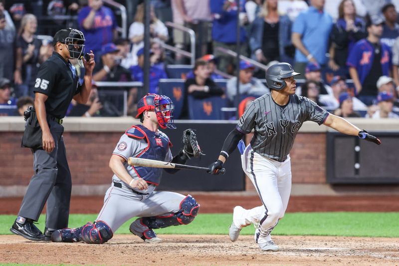 Sep 20, 2025; New York City, New York, USA; New York Mets right fielder Juan Soto (22) hits an RBI single in the ninth inning against the Washington Nationals at Citi Field. Mandatory Credit: Wendell Cruz-Imagn Images