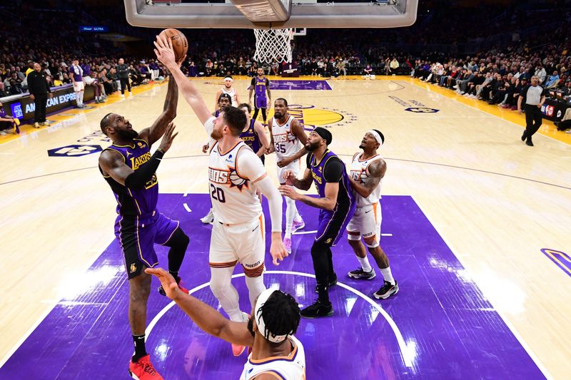 LOS ANGELES, CA - JANUARY 11: Jusuf Nurkic #20 of the Phoenix Suns blocks the shot by LeBron James #23 of the Los Angeles Lakers during the game on January 11, 2024 at Crypto.Com Arena in Los Angeles, California. NOTE TO USER: User expressly acknowledges and agrees that, by downloading and/or using this Photograph, user is consenting to the terms and conditions of the Getty Images License Agreement. Mandatory Copyright Notice: Copyright 2024 NBAE (Photo by Adam Pantozzi/NBAE via Getty Images)