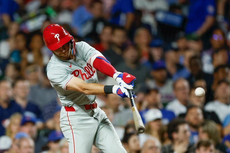 Jul 2, 2024; Chicago, Illinois, USA; Philadelphia Phillies shortstop Trea Turner (7) hits an RBI-single against the Chicago Cubs during the seventh inning at Wrigley Field. Mandatory Credit: Kamil Krzaczynski-USA TODAY Sports