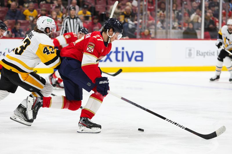 Dec 8, 2023; Sunrise, Florida, USA; Florida Panthers center Eetu Luostarinen (27) moves the puck ahead of Pittsburgh Penguins center Jansen Harkins (43) during the first period at Amerant Bank Arena. Mandatory Credit: Sam Navarro-USA TODAY Sports