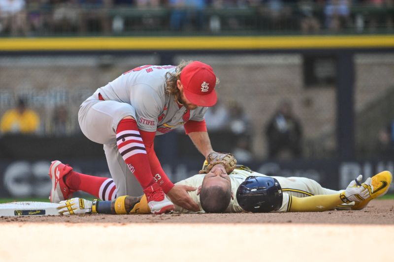 Sep 2, 2024; Milwaukee, Wisconsin, USA; St. Louis Cardinals second baseman Brendan Donovan (33) checks on Milwaukee Brewers third baseman Joseph Ortiz (3) after a collision in the fourth inning at American Family Field. Mandatory Credit: Benny Sieu-USA TODAY Sports