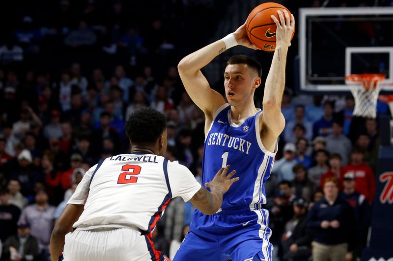 Jan 31, 2023; Oxford, Mississippi, USA; Kentucky Wildcats guard CJ Fredrick (1) looks for an open lane as Mississippi Rebels guard TJ Caldwell (2) defends during the first half at The Sandy and John Black Pavilion at Ole Miss. Mandatory Credit: Petre Thomas-USA TODAY Sports