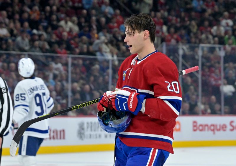 Oct 9, 2024; Montreal, Quebec, CAN; Montreal Canadiens forward Juraj Slafkovsky (20) puts back on his helmet during the third period of the game against the Toronto Maple Leafs at the Bell Centre. Mandatory Credit: Eric Bolte-Imagn Images