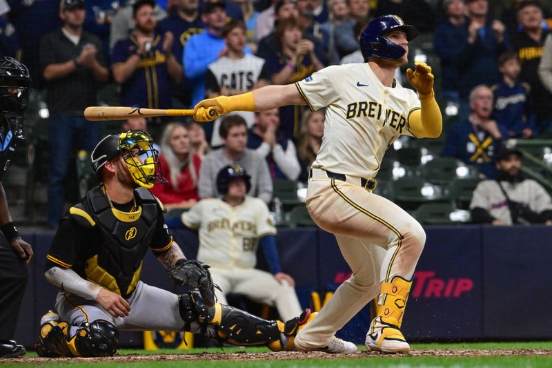 May 13, 2024; Milwaukee, Wisconsin, USA; Milwaukee Brewers left fielder Jake Bauers (9) hits a grand slam home run in the eighth inning as Pittsburgh Pirates catcher Yasmani Grandal (6) looks on at American Family Field. Mandatory Credit: Benny Sieu-USA TODAY Sports