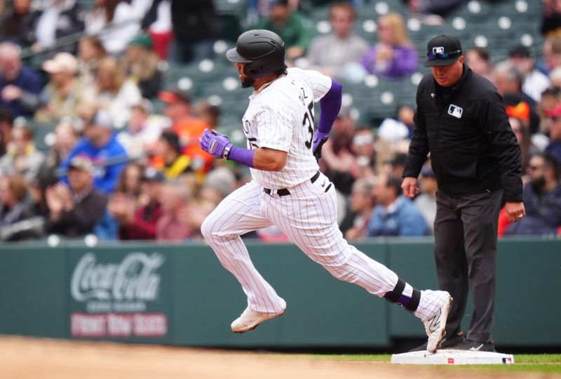 May 9, 2024; Denver, Colorado, USA; Colorado Rockies catcher Elias Díaz (35) rounds first base after hitting a double in the fourth inning against the San Francisco Giants at Coors Field. Mandatory Credit: Ron Chenoy-USA TODAY Sports